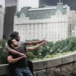 Deux silhouettes face à face dans la nuit new-yorkaise illuminée de néons, tension palpable entre elles