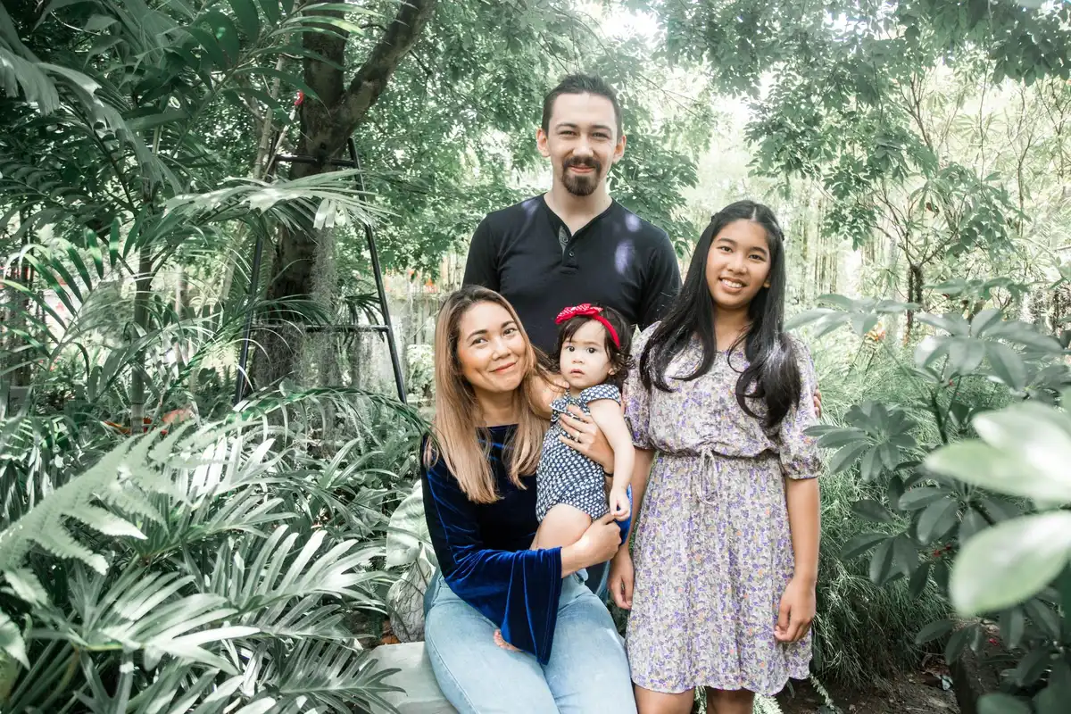 Parents et enfants passent du temps ensemble dans un jardin tropical