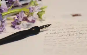Main anonyme feuilletant un manuscrit sur une table d'écrivain bien éclairée